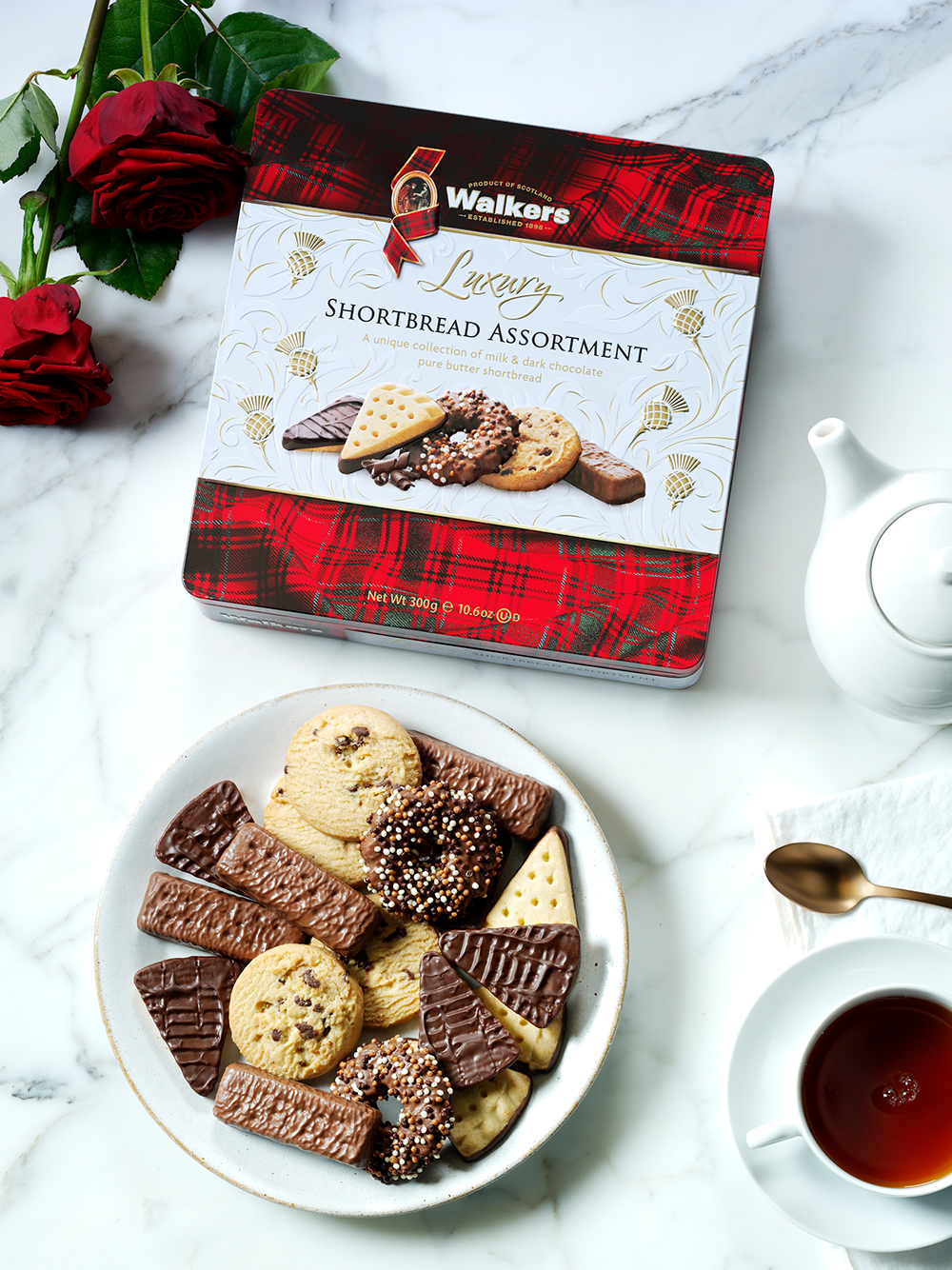Walkers Chocolate Shortbread Assortment on a table with red roses and a cup of tea