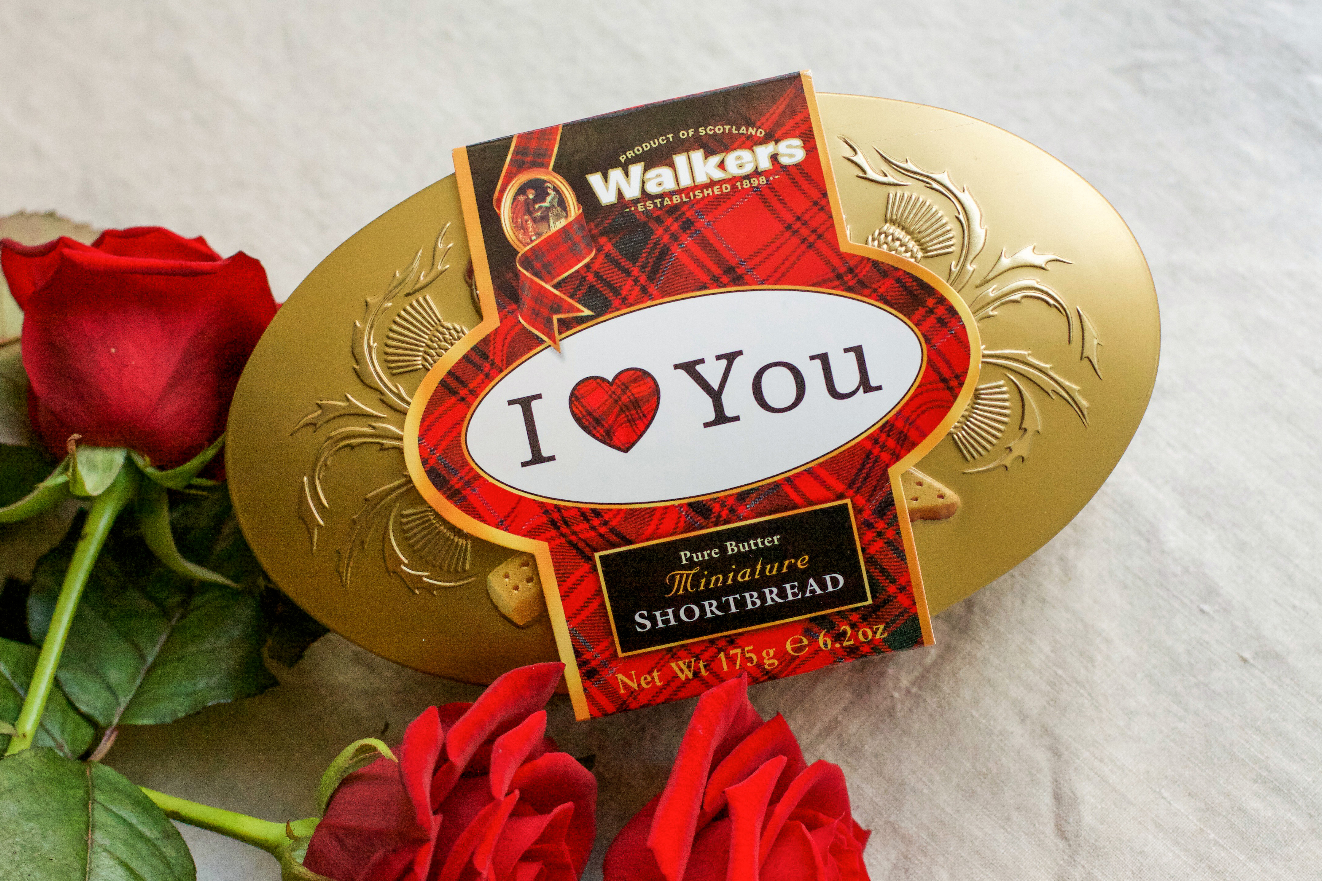Walkers 'I Love You' tin on a table with a red roses
